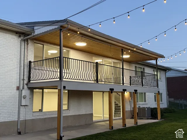 Upper-level deck with decorative metal railing and recessed lighting