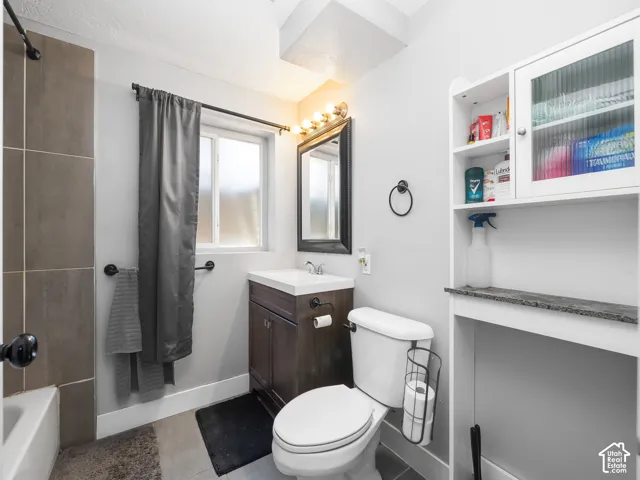 Vanity with integrated sink, rectangular mirror, and overhead lighting