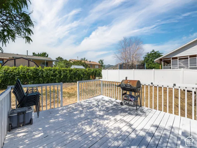 Expansive outdoor deck with white painted wood planks and railing