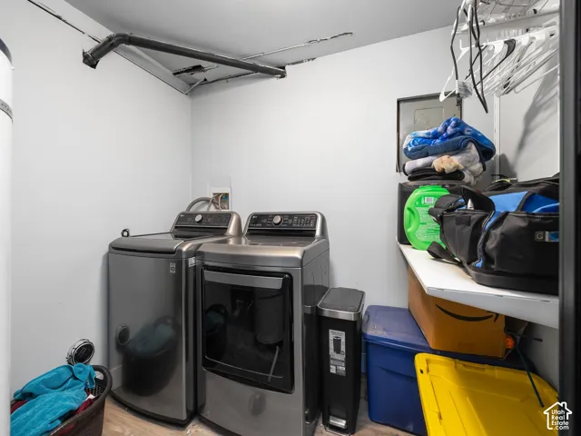 Laundry area featuring an exposed pipe and a built-in shelf