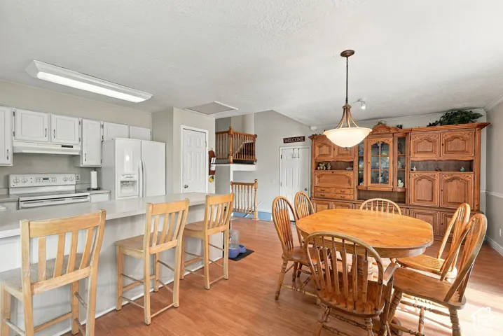 Kitchen with white cabinetry, a kitchen island, and a built-in range