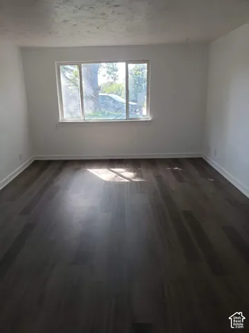 Hardwood-style flooring and white walls