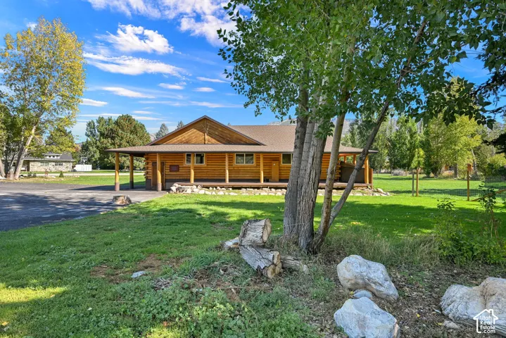 Log cabin exterior with 1,100 sq ft covered porch