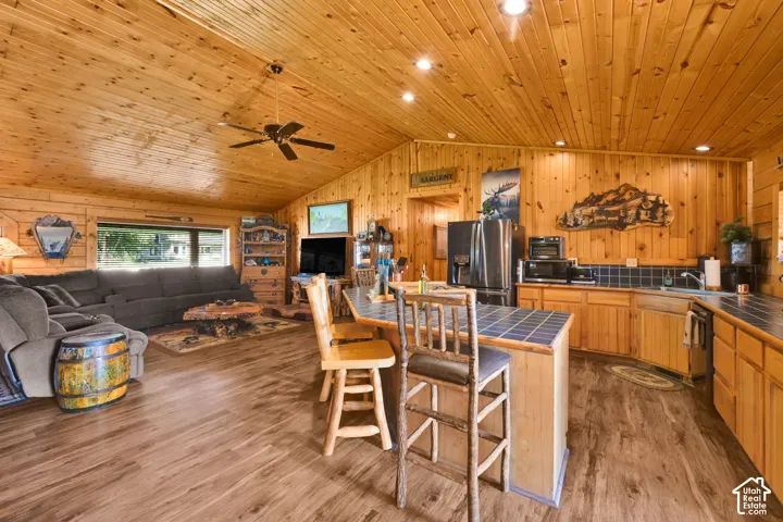 Open Kitchen with immaculate wood detailing, vaulted ceiling and island.