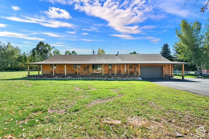 View from the street of the lot, driveway, 2 car garage and 1,100 sq foot covered patio.