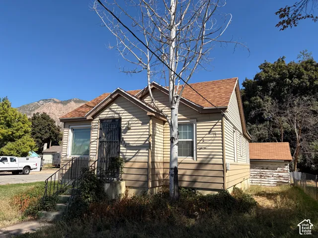 Siding exterior with multiple windows and a mountain backdrop