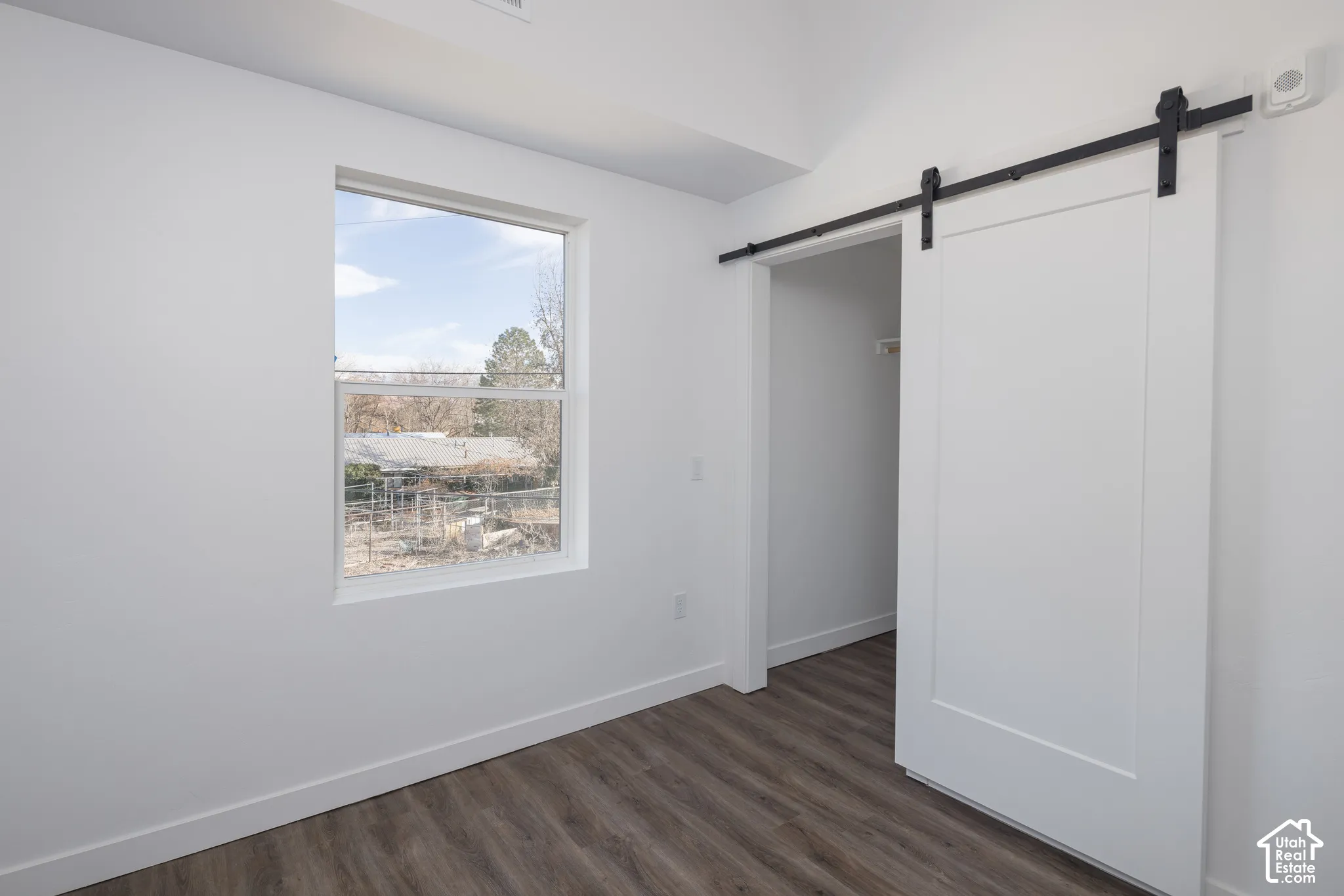 Wood-finish flooring with white walls and trim