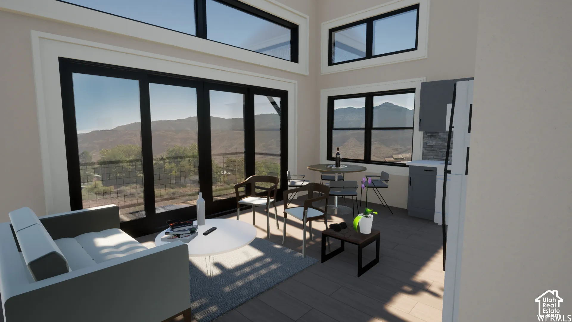 Floor-to-ceiling glass sliding doors, transom windows, wood-finish flooring, and a kitchen featuring a tile backsplash and gray cabinetry