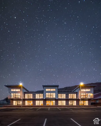 Modern architectural building with multiple balconies and expansive windows