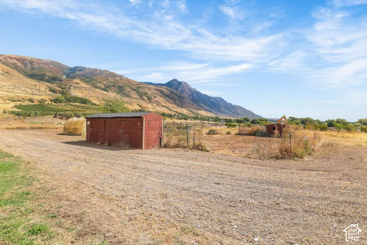 Red-sided storage shed with a dark roof