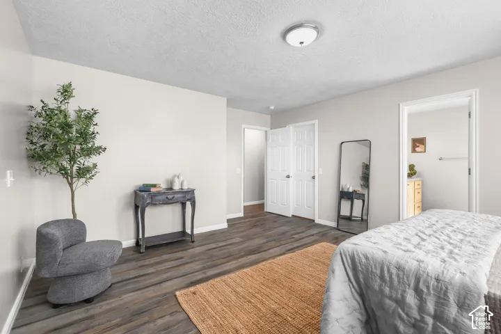 Wood-finish flooring, light-toned walls, and a flush mount ceiling light