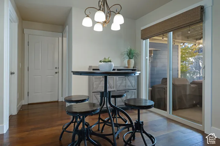Wood-finish flooring, white paneled door, sliding glass patio door, and recessed lighting
