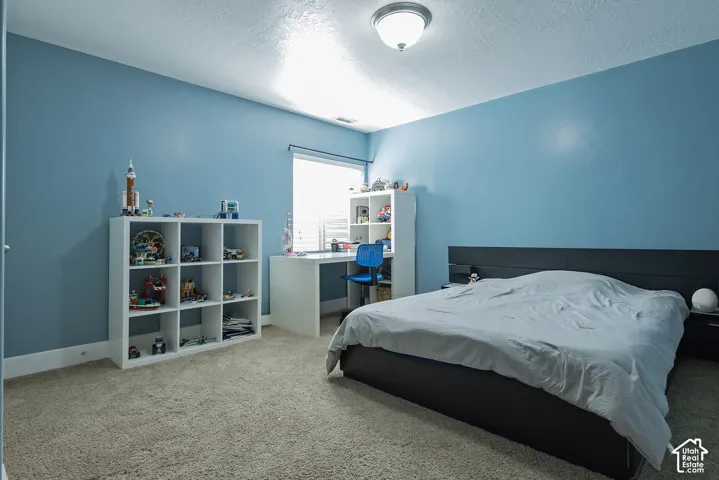 Wall-to-wall carpet flooring, light blue painted walls, recessed window, and flush mount ceiling light