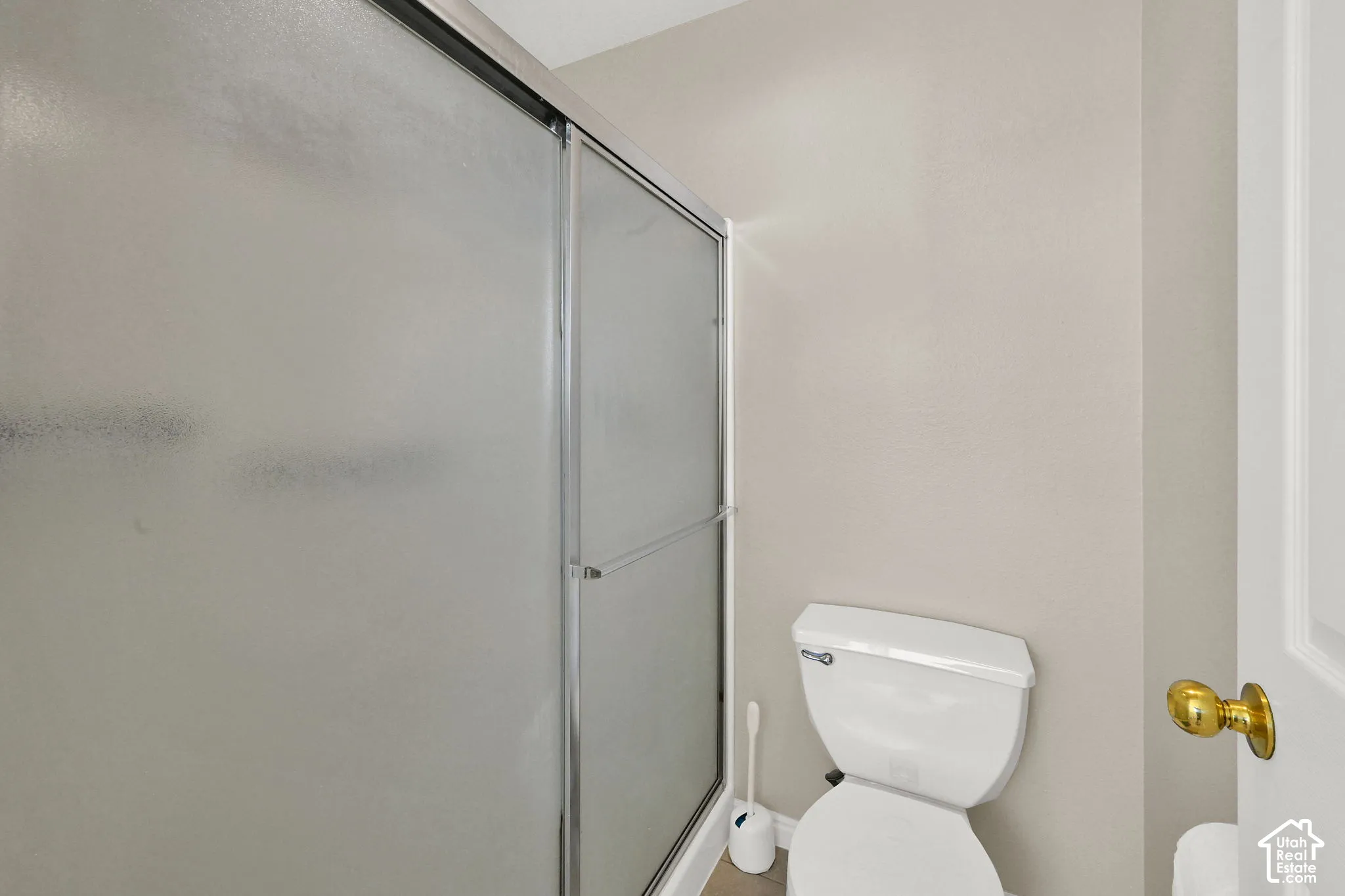 Primary Bathroom Shower with frosted glass enclosure and sliding door