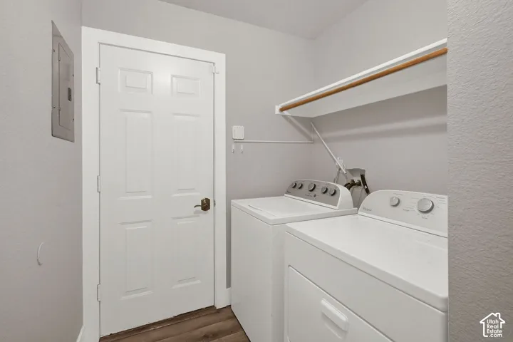 Wood-finish flooring with a white six-panel interior door