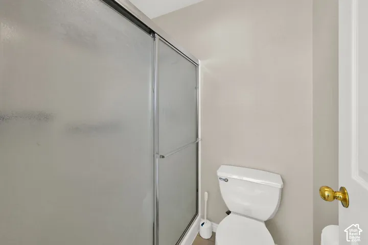 Primary Bathroom Shower with frosted glass enclosure and sliding door