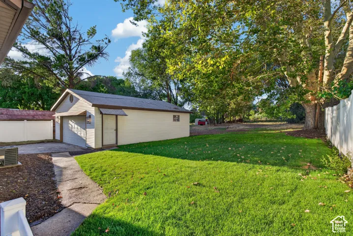 Detached garage with gabled roof and roll-up door