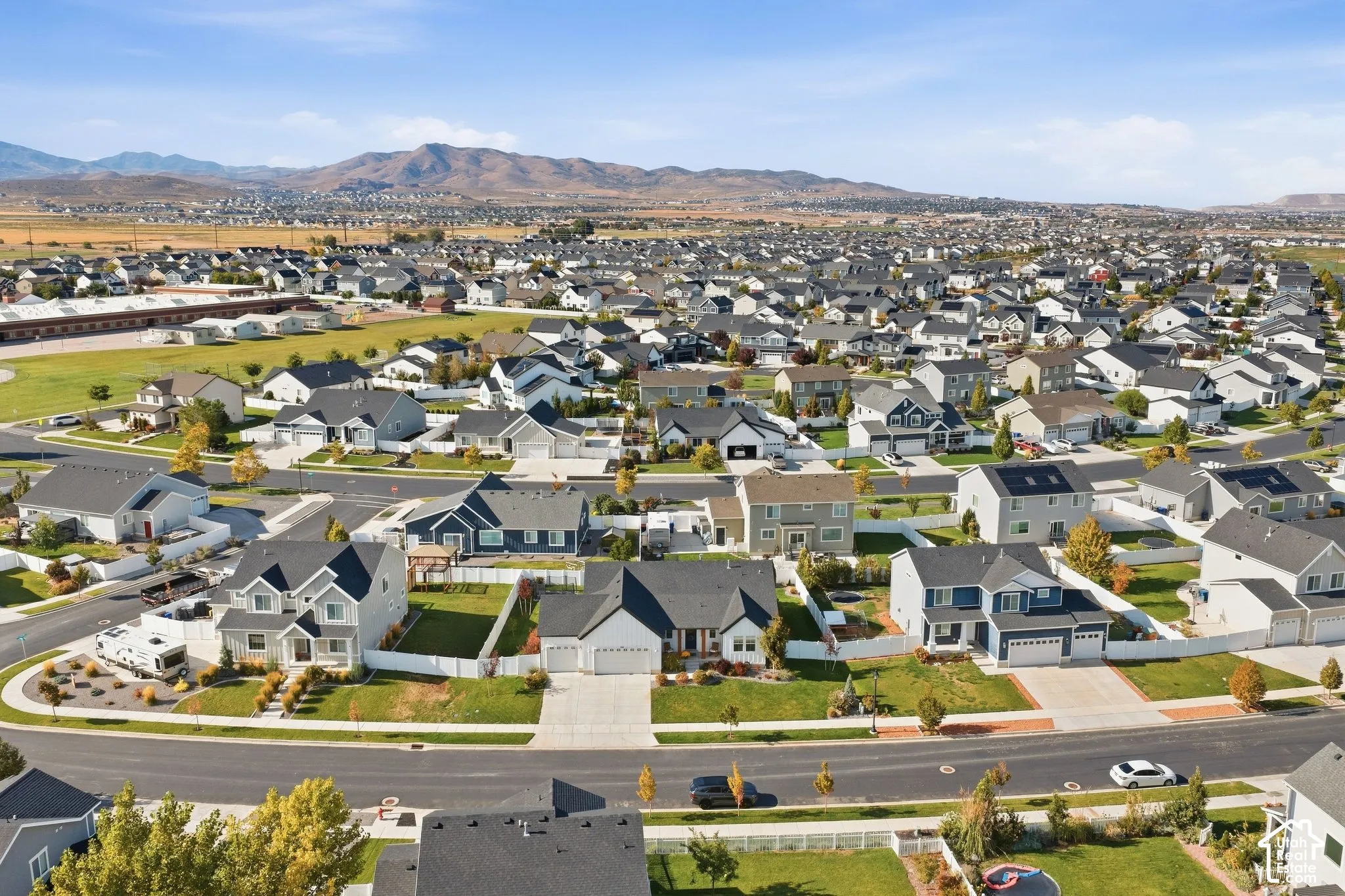 Expansive residential neighborhood with consistent architectural styles and mountain scenery