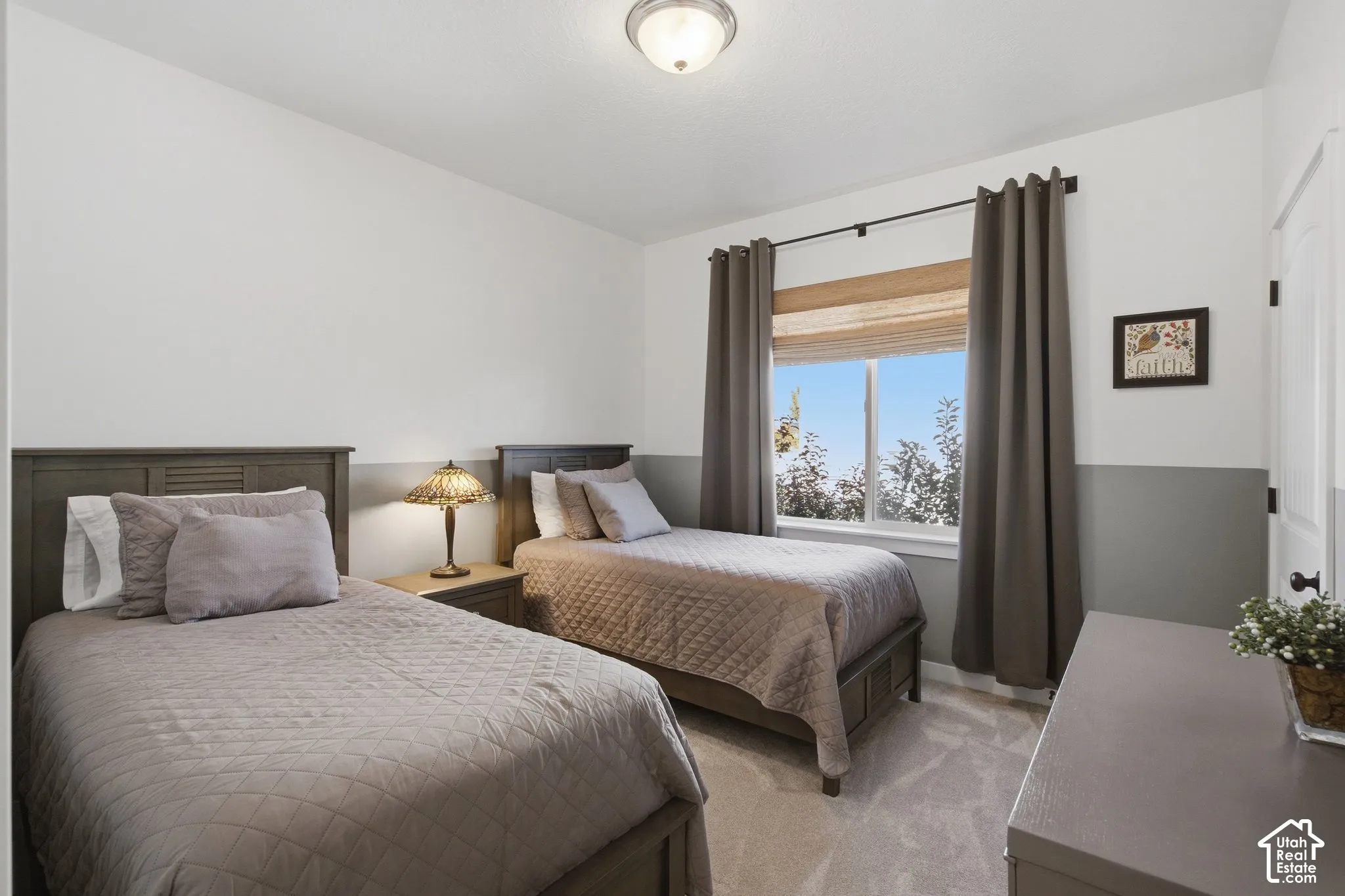 Carpeted room with a ceiling-mounted light fixture
