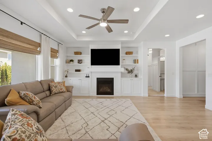 Recessed lighting, tray ceiling, and a ceiling fan