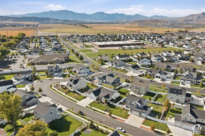 Established residential neighborhood with a variety of architectural styles, mountain backdrop, and green spaces