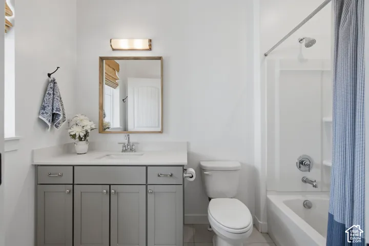 White vanity with gray cabinetry and brushed nickel hardware