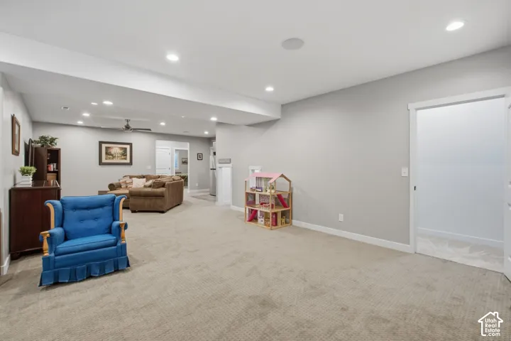 Recessed lighting, light gray wall tones, and carpet flooring