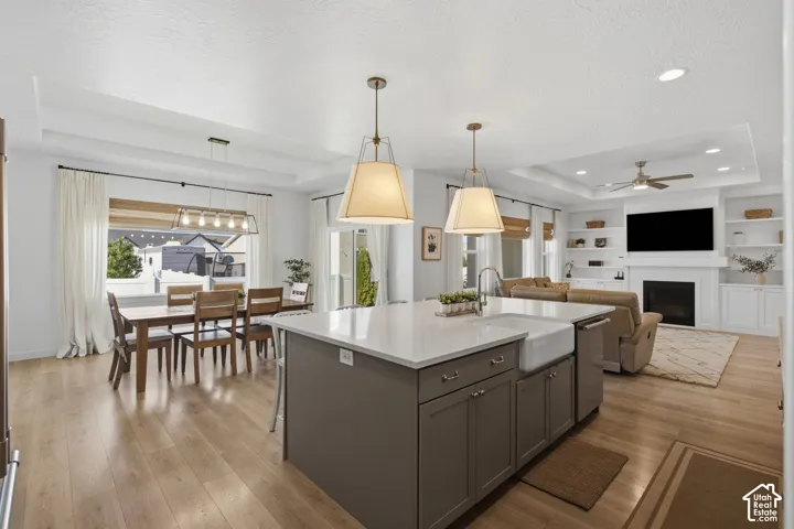Central kitchen island with a farmhouse sink and pendant lighting