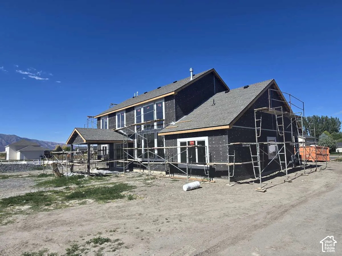 New construction with asphalt shingle roofing and multiple gables