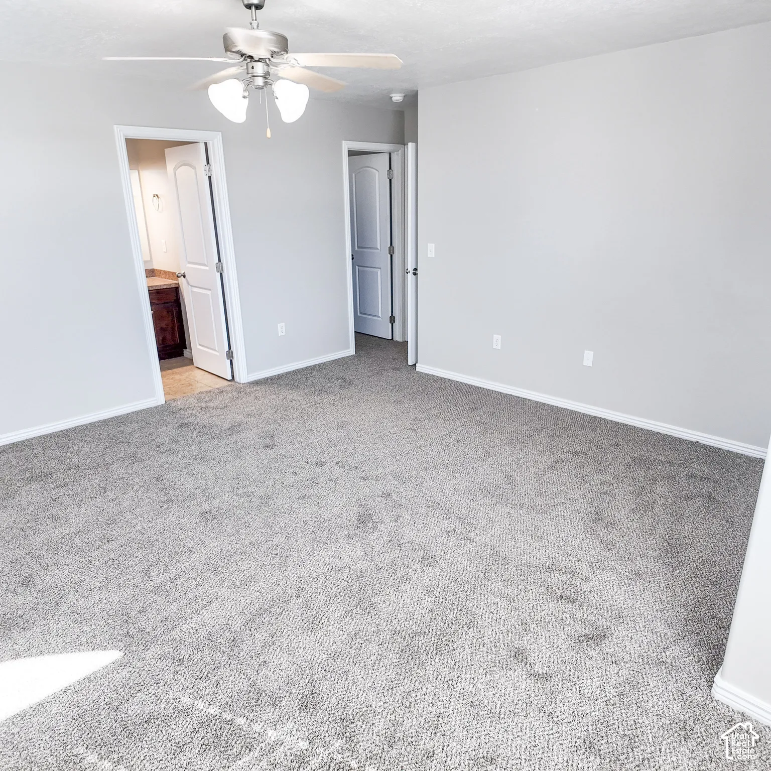 Recessed lighting, ceiling fan, and light gray wall paint