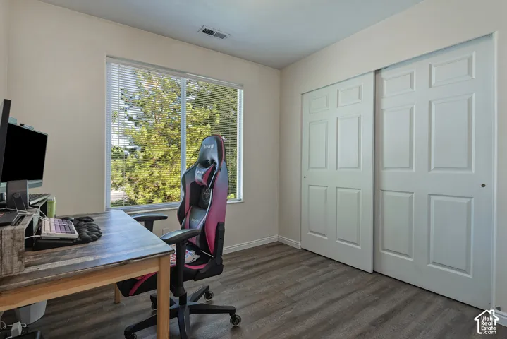 Laminate wood-finish flooring, sliding panel closet doors, and window with blinds