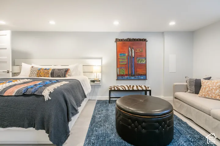 Recessed lighting illuminates wood-finish flooring