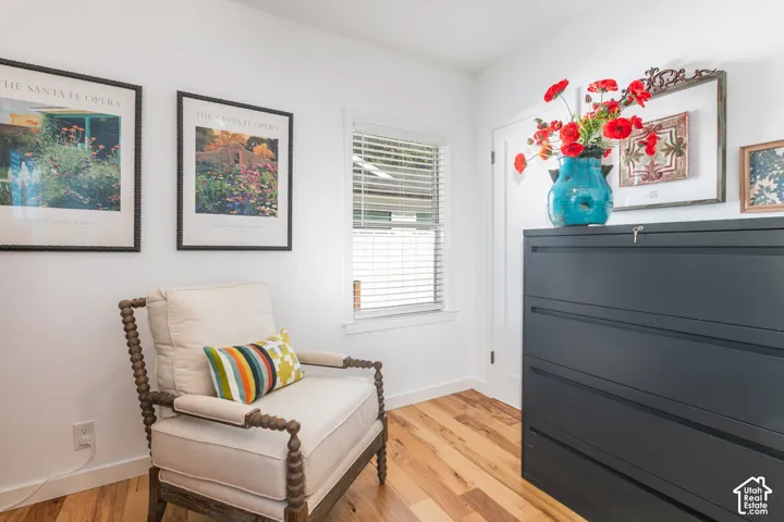 Wood-finish flooring with white baseboards