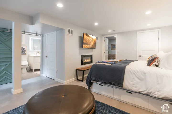 Recessed lighting, wood-finish flooring, and built-in electric fireplace