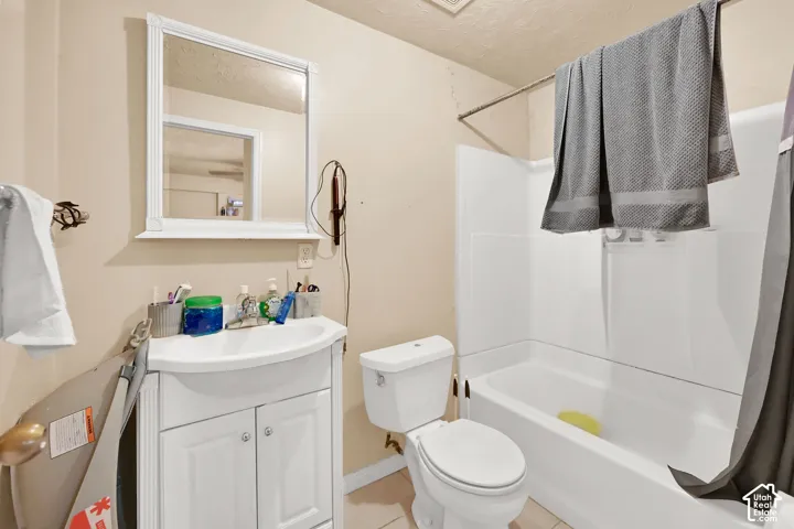 Bathroom with a white vanity, integrated sink, and white cabinetry