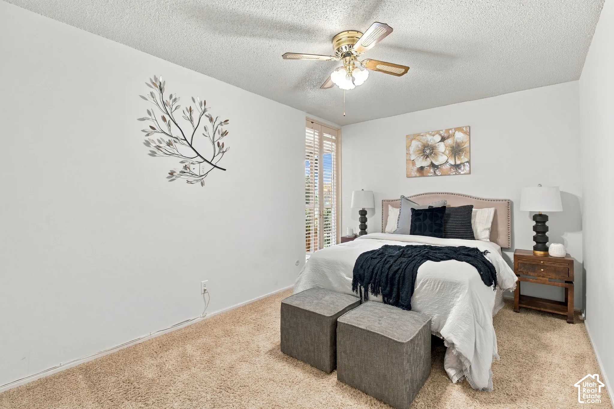 Carpeted flooring, ceiling fan with integrated lighting, and window with plantation shutters