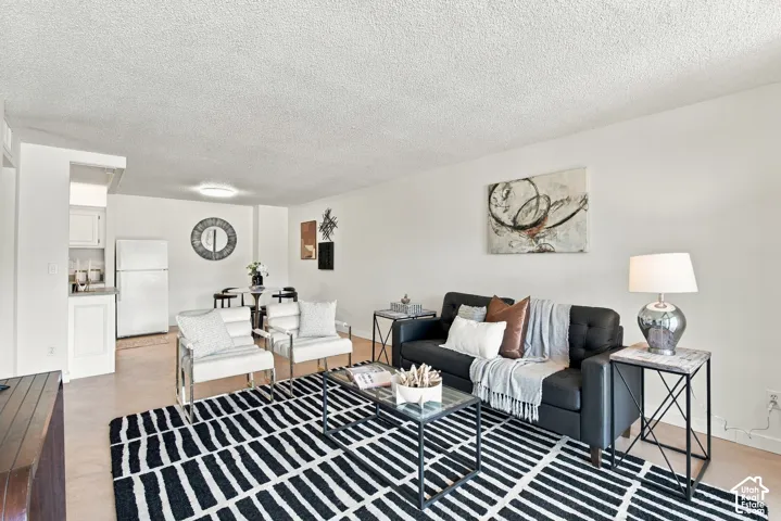 Open-concept living area with light-colored walls and overhead lighting