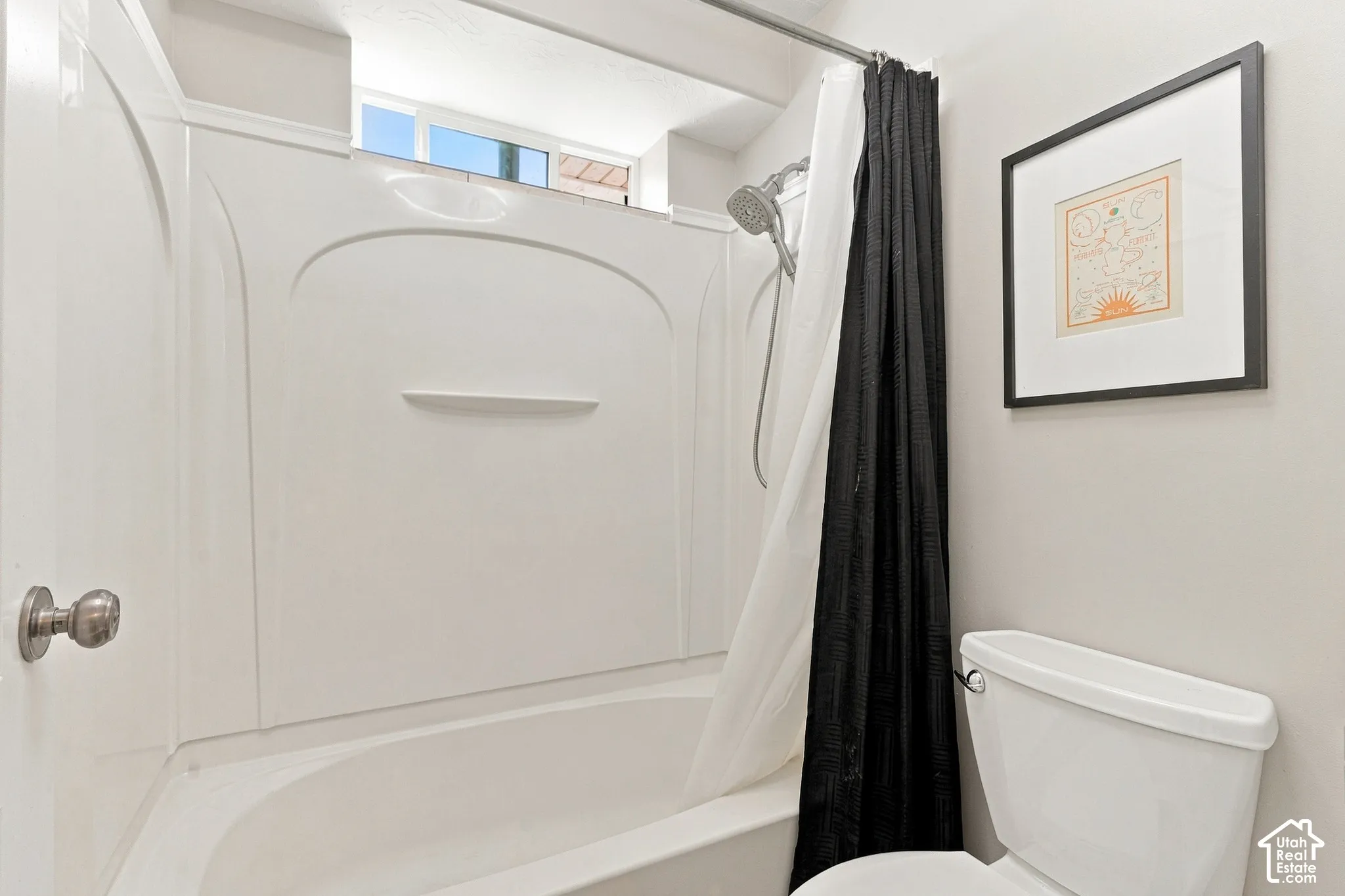 White bathtub with an integrated shower, featuring a handheld showerhead