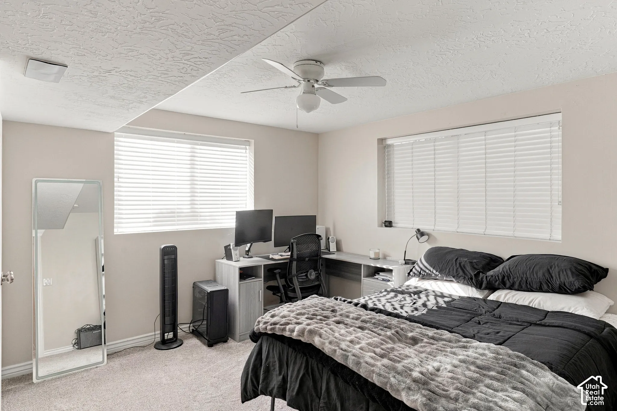 Recessed window with horizontal blinds, overhead ceiling fan with lighting, and neutral-toned wall paint
