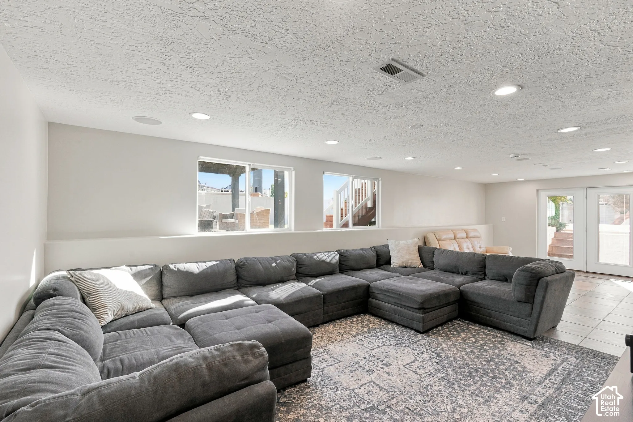 Recessed lighting, dual windows, French doors, and tile flooring