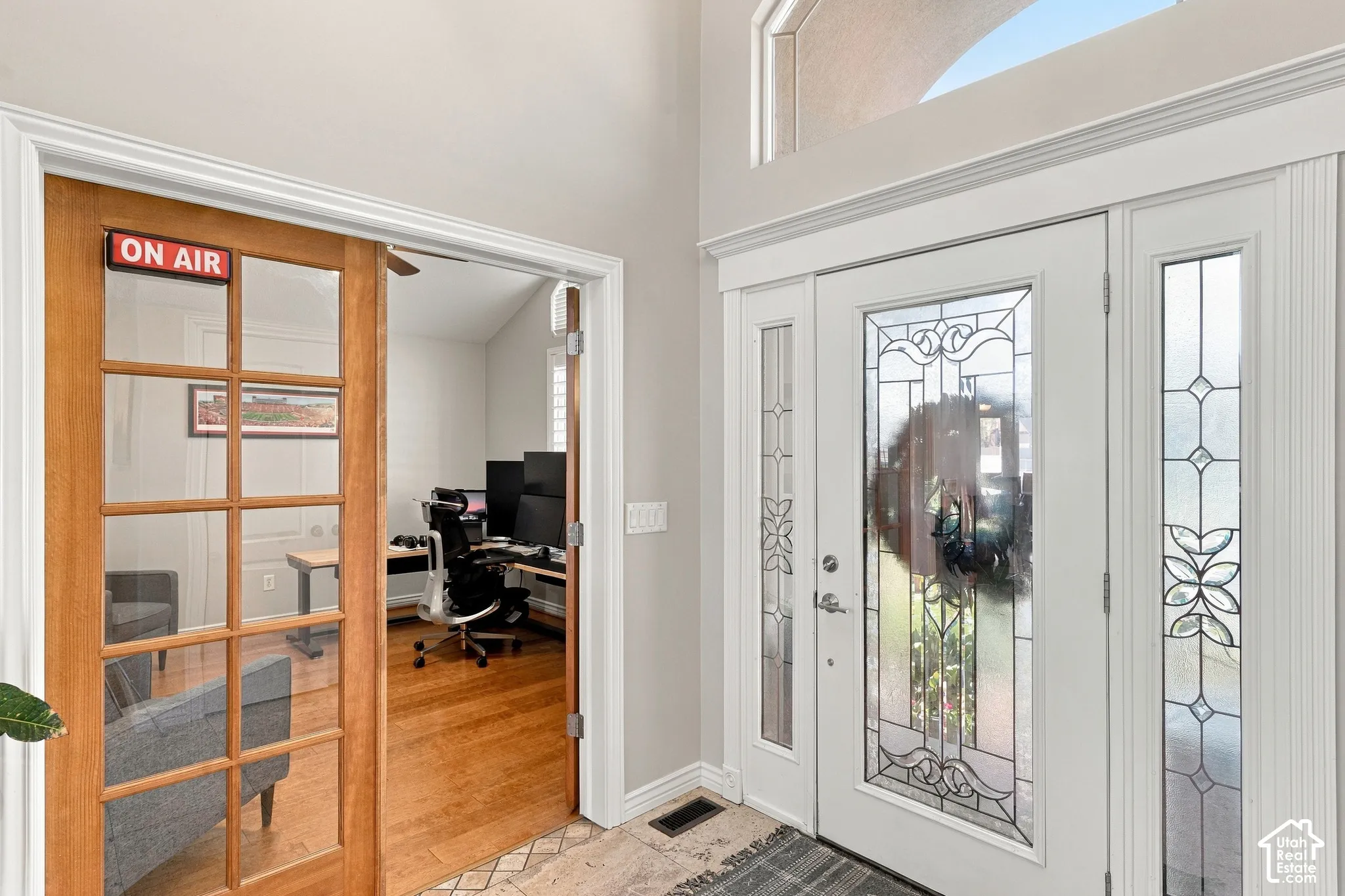 Leaded glass entry door with frosted sidelights and an arched transom