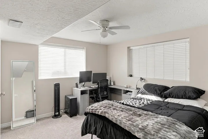 Recessed window with horizontal blinds, overhead ceiling fan with lighting, and neutral-toned wall paint