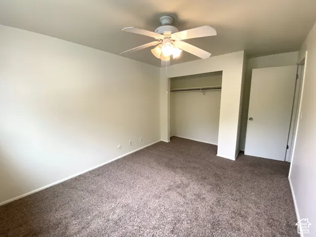 Neutral wall paint, brown carpet flooring, ceiling fan with integrated lighting, recessed closet, and white interior door