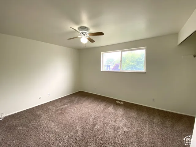 Neutral-toned walls complement the brown carpet flooring