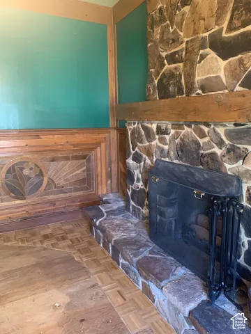 Stone fireplace featuring a wood mantle and stone hearth