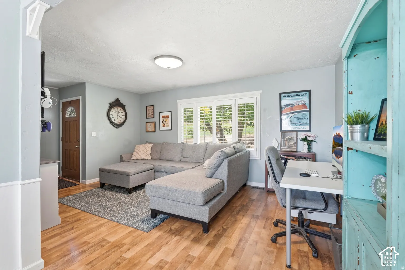 Wood-finish flooring throughout, light gray wall color, and white window shutters