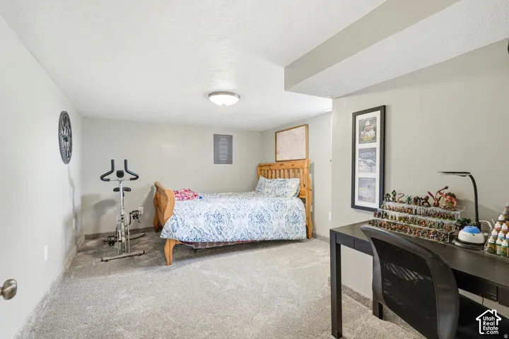 Neutral wall tones, recessed ceiling beam, flush-mount ceiling light, and wall-to-wall carpeting
