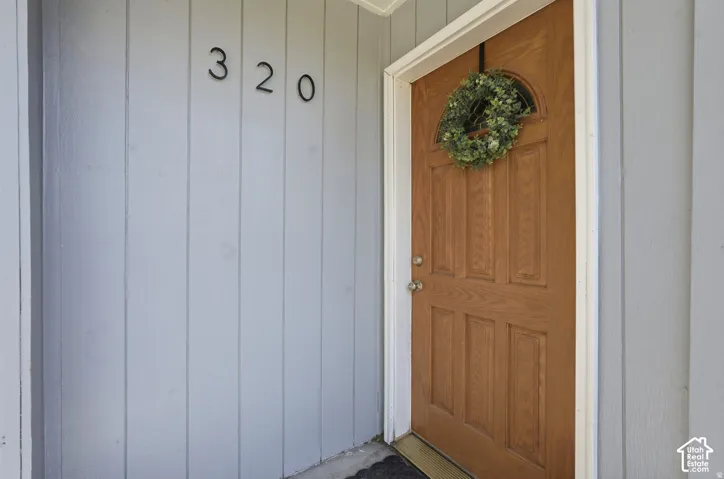 Wood-paneled entry door with an arched transom window