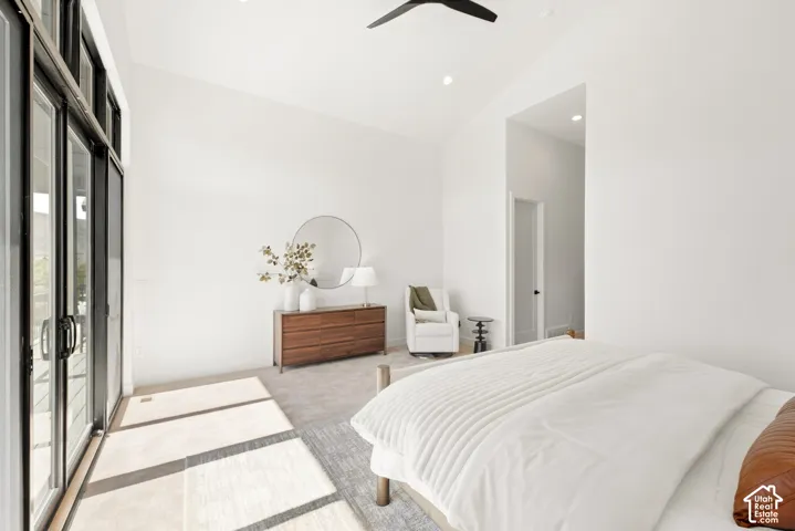 Vaulted ceiling with recessed lighting and a ceiling fan