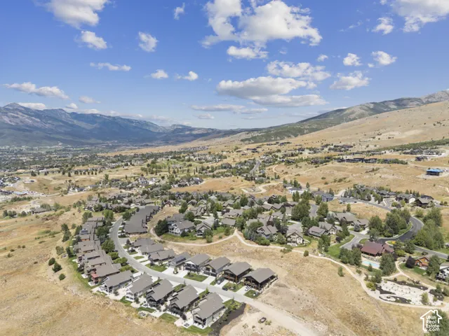 Expansive mountain scenery framing a residential community with varied architectural styles